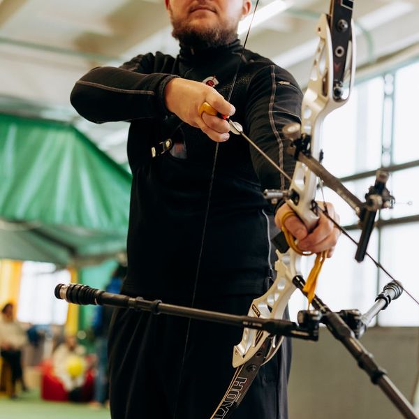 Close-up of a man focused during a complex balance exercise.